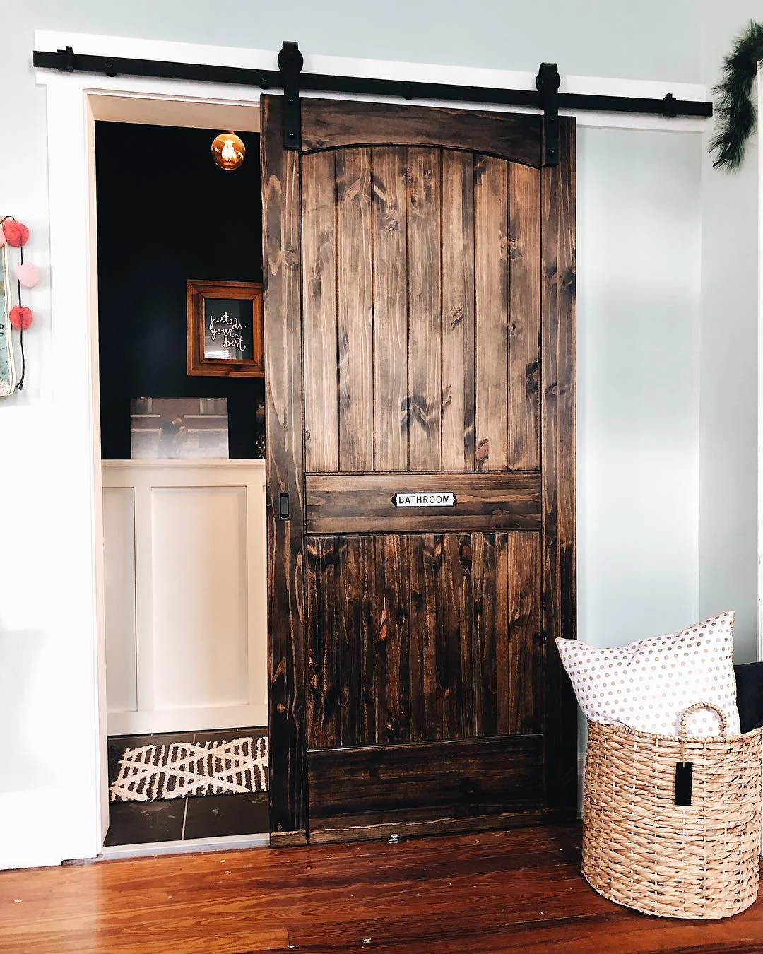 Dark Wood Barn Door with Bathroom Sign