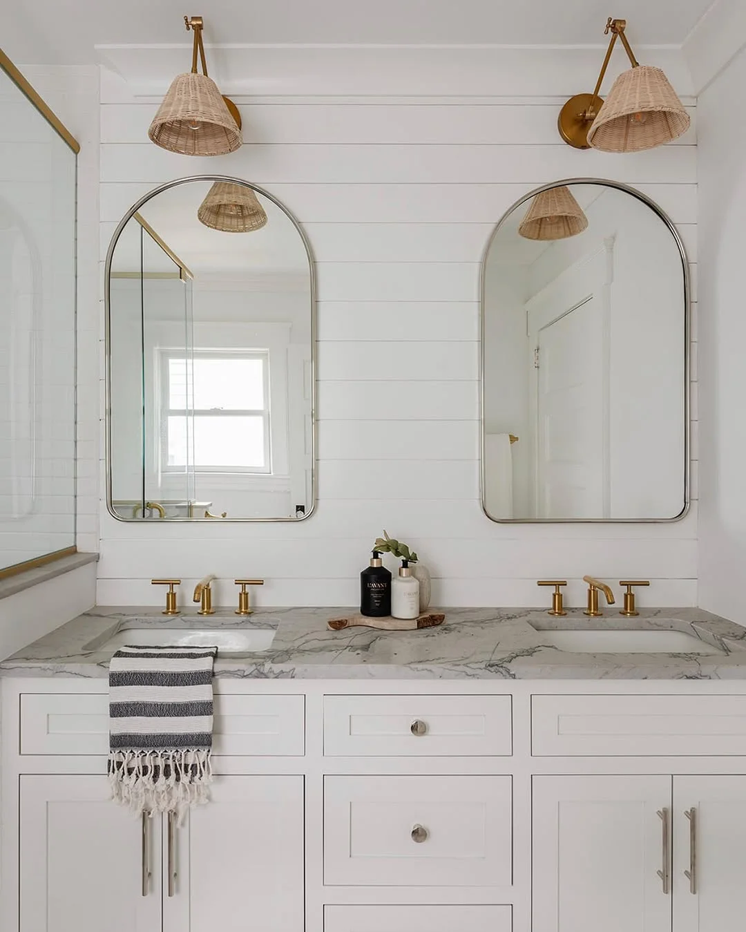 Coastal Bathroom with Arched Mirrors and Woven Sconces