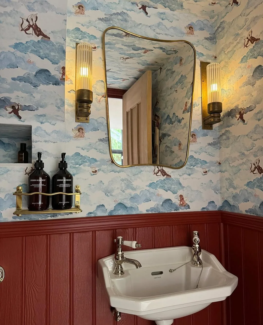 Playful Bathroom with Cloud Wallpaper and Wavy Mirror