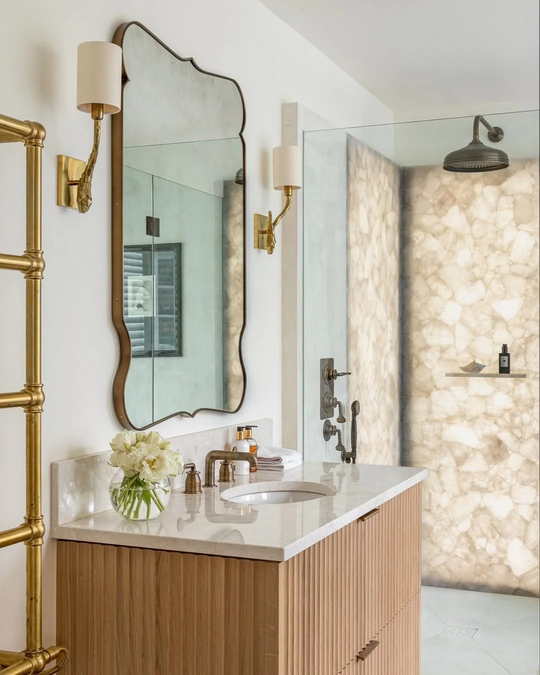 Elegant Bathroom with Fluted Vanity and Ornate Mirror