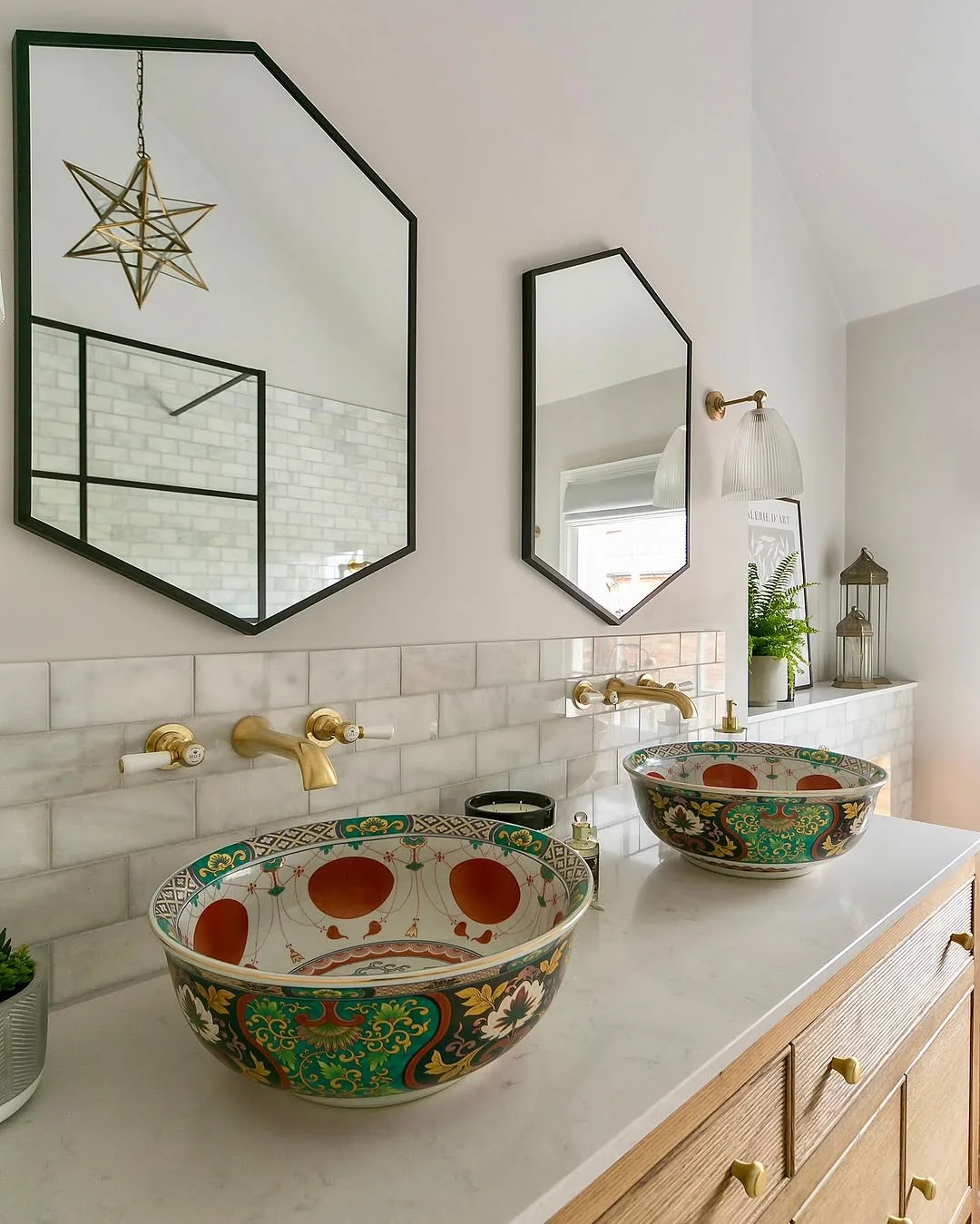 Eclectic Bathroom with Geometric Mirrors and Decorative Sinks