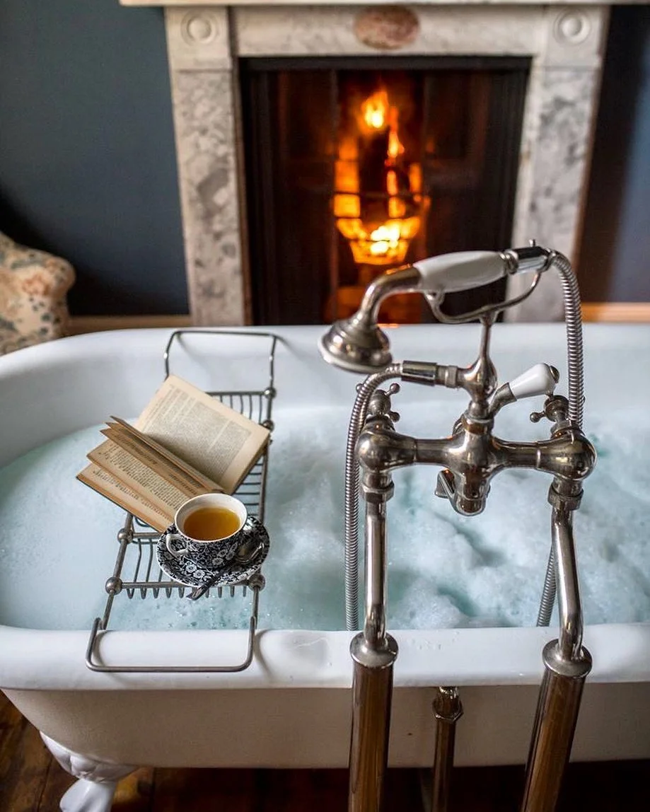 Cozy Bath with Fireplace and Book Caddy