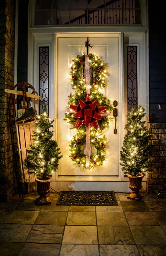 Enchanting Porch with Lit Christmas Wreaths and Trees