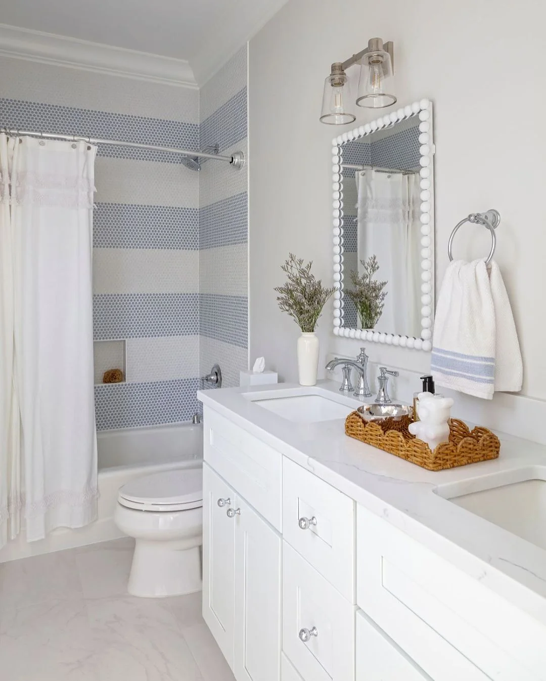 Fresh and Airy Bathroom with Penny Tile Accent