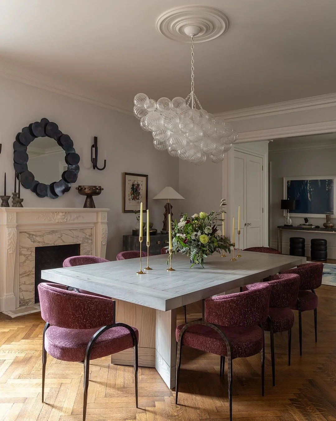 Sophisticated Dining Room with Sculptural Chandelier and Round Mirror