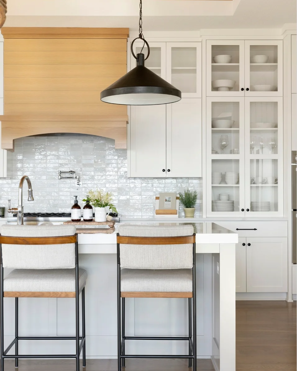 Timeless White Kitchen Cabinets with Glass Doors and a Subtle Wood Vent