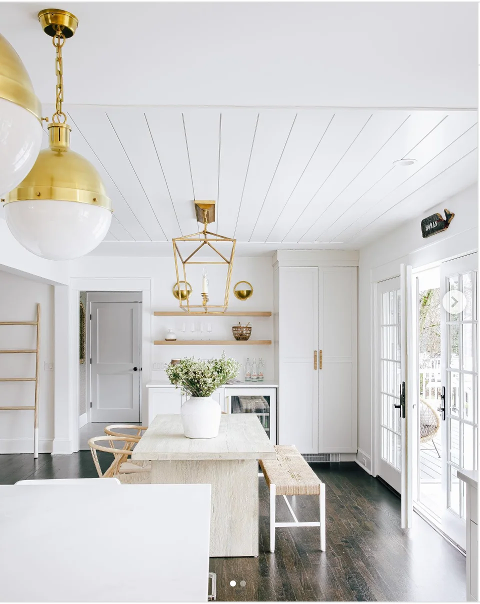 White and Gold Dining Room with Dark Wood Flooring