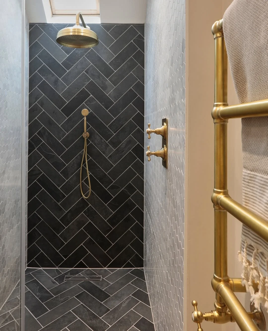 Chic Black Herringbone Shower with Gold Accents