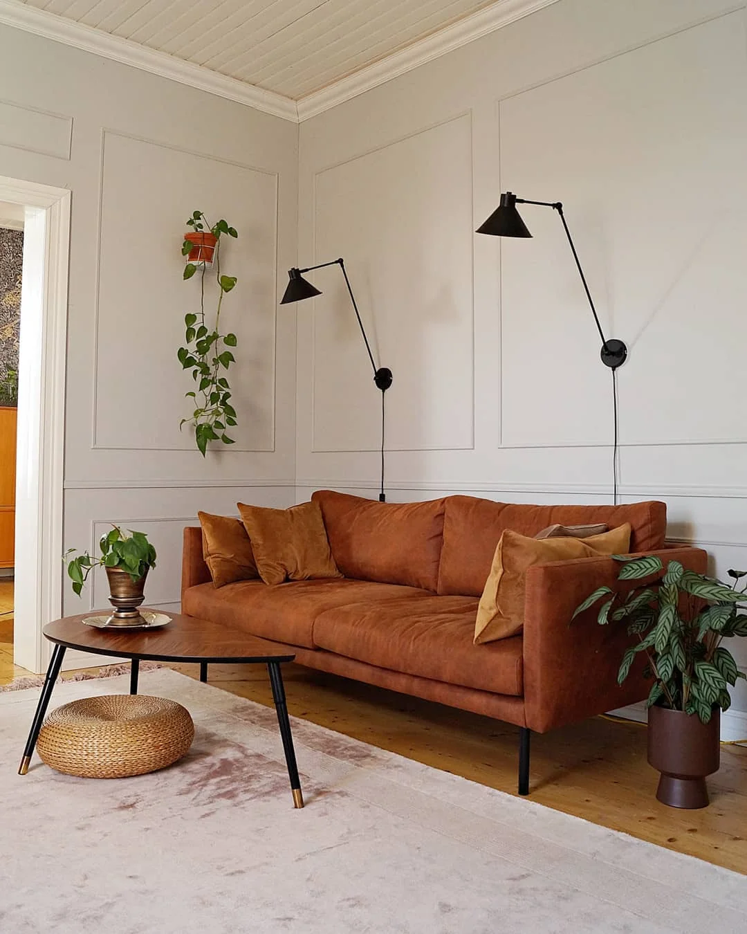 Minimalist Living Room with Tan Sofa and Wall Lamps