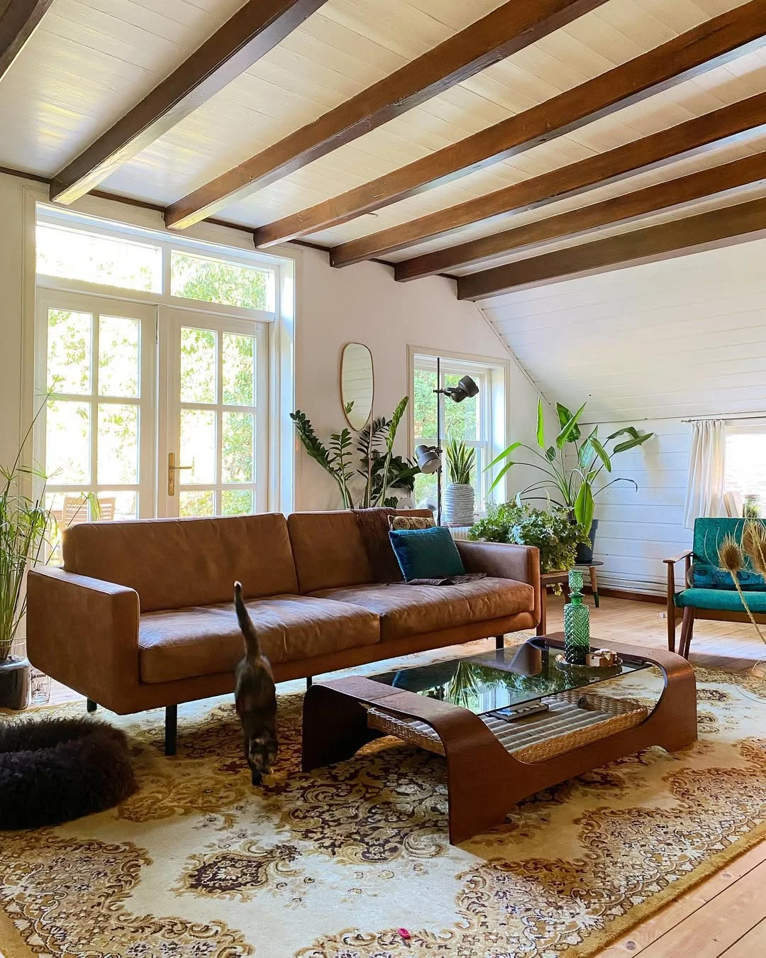 Retro Living Room with Tan Leather Sofa and Exposed Beams