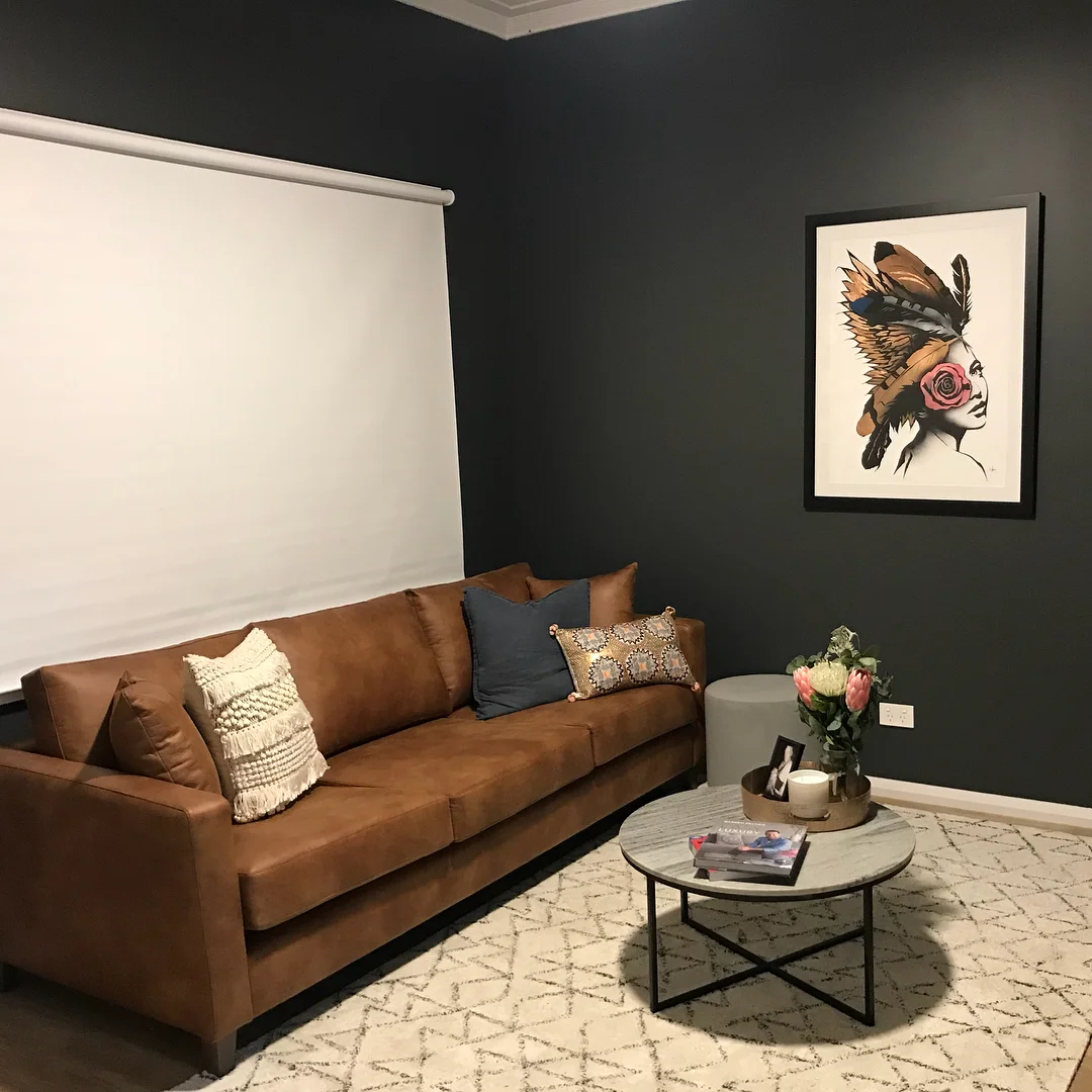 Modern Tan Leather Sofa with Dark Walls