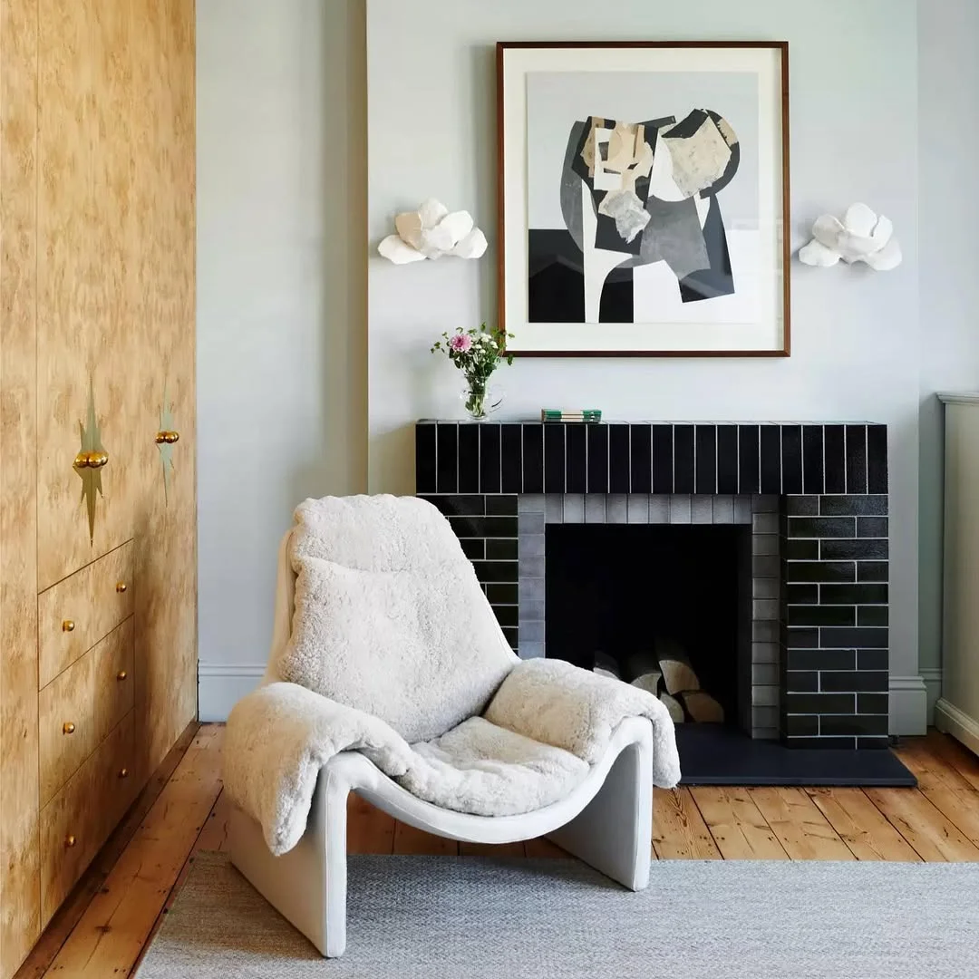 Modern Fireplace with Black Tile and Cozy Sheepskin Chair