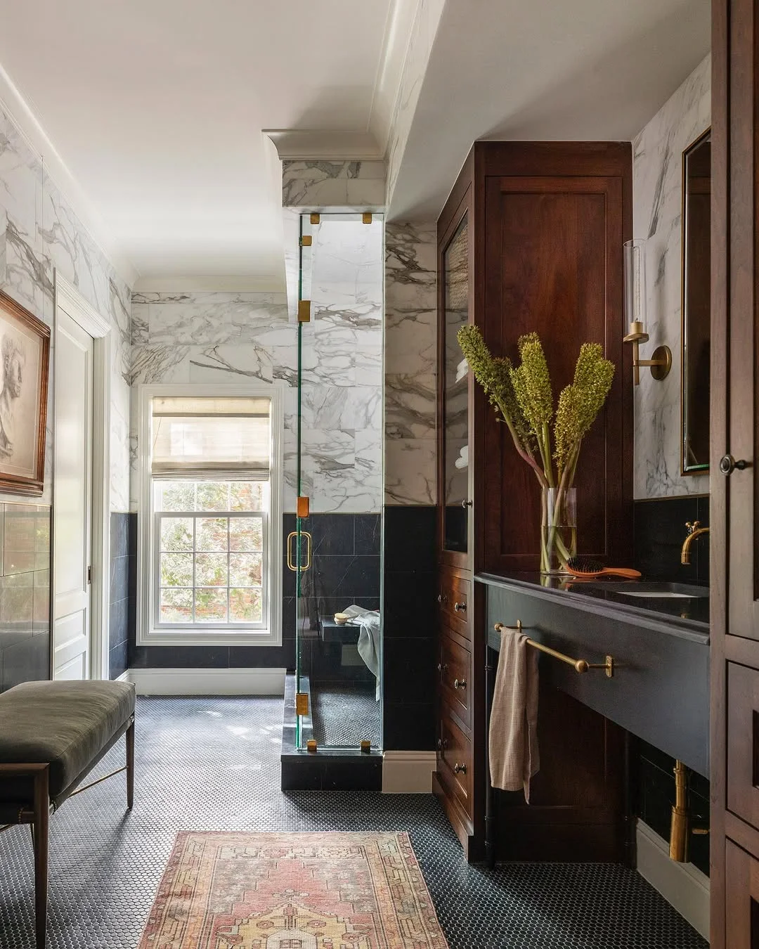 Elegant Bathroom with Marble, Dark Tile, and Rich Wood Tones