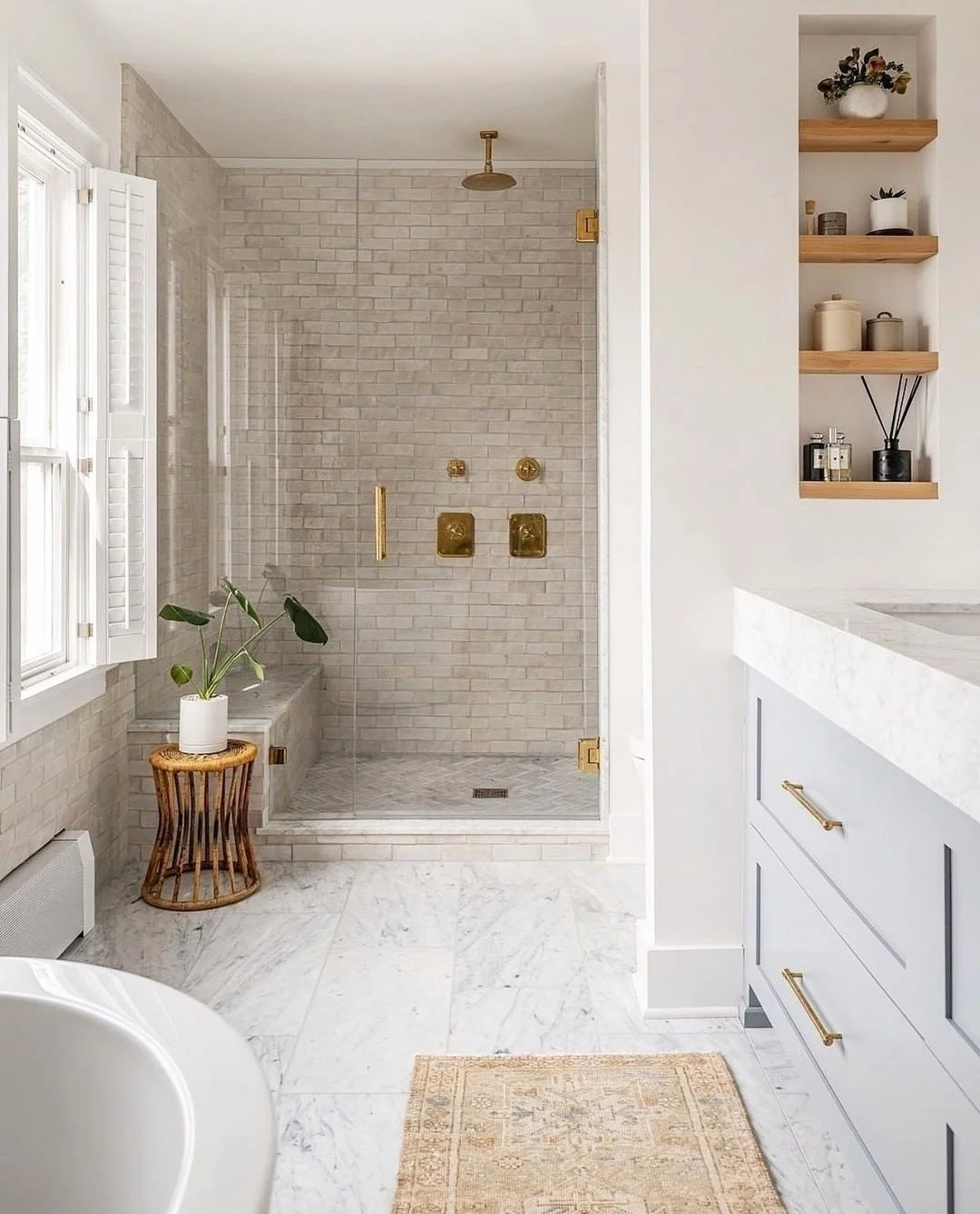 Serene Bathroom with Light Brick Walk-In Shower and Gold Accents