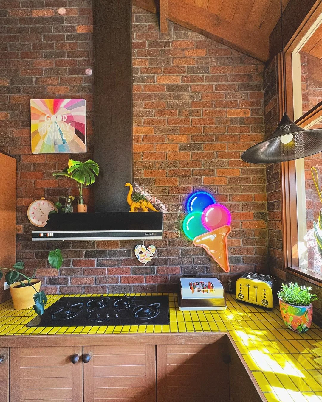 Bold Yellow Tile Countertops and Brick Backdrop